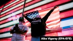 Supporters of President-Elect Joe Biden and Vice-President-Elect Kamala Harris gather in New York City's Time Square to watch a Biden speech after news organizations called the 2020 presidential election for the Democratic Party's candidate. 