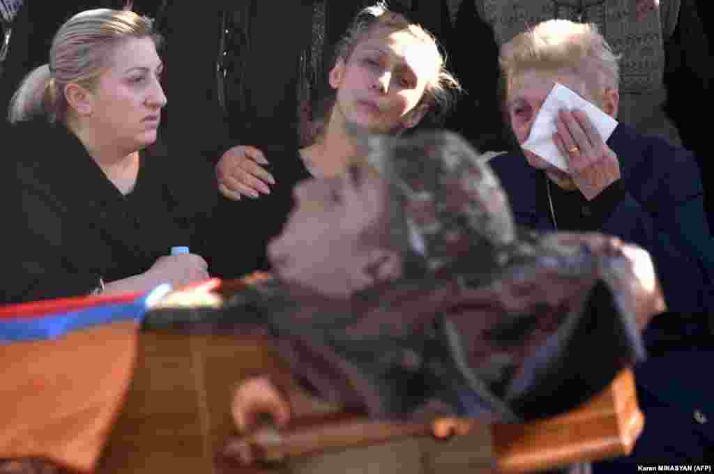 During an October 10 funeral in Yerevan's Yerablur military cemetery, relatives respond to the death of Armenian soldier Vazgen Aslanian, one of 542 Armenian armed forces personnel killed since fighting with Azerbaijan over the breakaway region of Nagorno-Karabakh resumed on September 27. &nbsp;