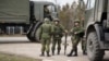 CRIMEA - Russian troops without identification marks near the blocked Ukrainian unit A-0883, Kerch, March 8, 2014