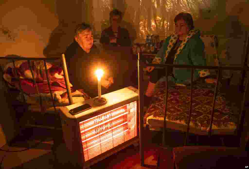 Women take refuge in a bomb shelter in Nagorno-Karabakh's main town of Stepanakert (Khankendi) on October 8, 2020. Aside from hitting civilian buildings in the town, shelling by Azerbaijani forces has periodically disrupted the town's electricity supplies.&nbsp;Nagorno-Karabakh human rights ombudsman Artak Beglaryan has reported 31 civilian deaths and hundreds wounded, according to the Associated Press.&nbsp;