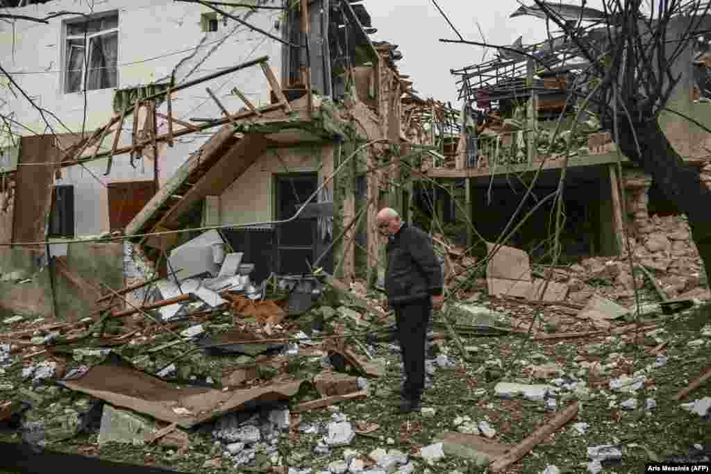 An elderly man stands in front of a destroyed house after shelling on the main Karabakhi town of Stepanakert (Khankendi) on October 7, 2020. For many of Karabakh's residents, the fighting is a repeat of the violence they experienced in the early 1990s, when sporadic fighting between Azerbaijanis, Armenians, and Armenia-backed Karabakhis led to full-scale war.&nbsp;&nbsp;